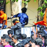 Palakkad: BJP workers jump a boundary wall during clashes with police during a protest amid a dawn-to-dusk Kerala shutdown called to denounce the visit of two women to the Sabarimala temple, that saw major violence, in Kerala’s Palakkad on Jan 3, 2019. (P