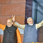 BJP chief Amit Shah and Prime Minister Narendra Modi wave at party workers during a party programme in New Delhi, on Thursday. IANS