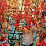 A vendor hangs decorative items in front of his shop ahead of Christmas in Kolkata, on 17 December 2018. REUTERS