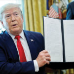 US President Donald Trump displays an executive order imposing fresh sanctions on Iran in the Oval Office of the White House in Washington, US, on 24 June. REUTERS