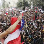 Demonstrators wave Chilean flag during a protest against social inequality in Chile.