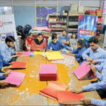 Visually-impaired at members of the Blind Relief Association making paper bags for the seven-day Diwali Bazaar.