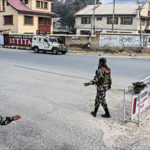 Security personnel keep vigil on a road. Photo Muzamil Bhat