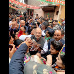 Home Minister Amit Shah distributing pamphlets in Delhi Cannt.