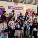 Kiren Rijiju, Minister for Youth Affairs and Sports , giving footballs to girls from from underprivileged families.