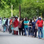 People stand in a queue to receive the dose of the COVID19 vaccine