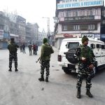 Security personnel stand guard at Lal Chowk during a strike called by separatist leaders against the alleged killing of civilians in the Hyderpora encounter