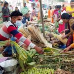 People purchase worshipping material at a market during the Chatth Puja