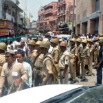 Police personnel stand guard as devotees arrive to offer Namaz at Gyanvapi Mosque,