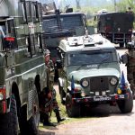 Security personnel patrol near the encounter site in Anantnag