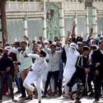 Protestors pelting stone during a protest