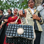 A girl is dressed up while holding a bag made up of computer equipment by the Odisha skill students at ‘Pathapranta Utsav’