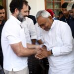 Nitish Kumar and Rahul Gandhi exchange greetings after a joint press conference with Mallikarjun Kharge