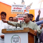 Virendra Sachdeva speaks during a protest