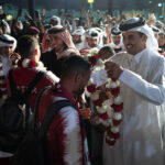 Emir Sheikh Tamim bin Hamad Al Thani gives flower necklace to Qatar players as they celebrate winning the Asian Cup