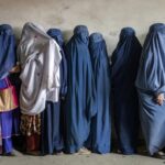 Afghan women wait to receive food rations distributed by a humanitarian aid group, in Kabul, Afghanistan, in May 2023. (File)