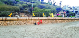 Yellow ribbons and Bring Them Home Now posters on Tel Aviv’s beach.