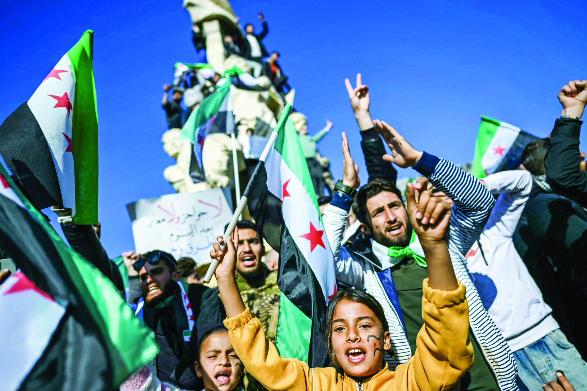 People in Syria’s Aleppo celebrate the fall of Assad during a rally on Friday. File Photo