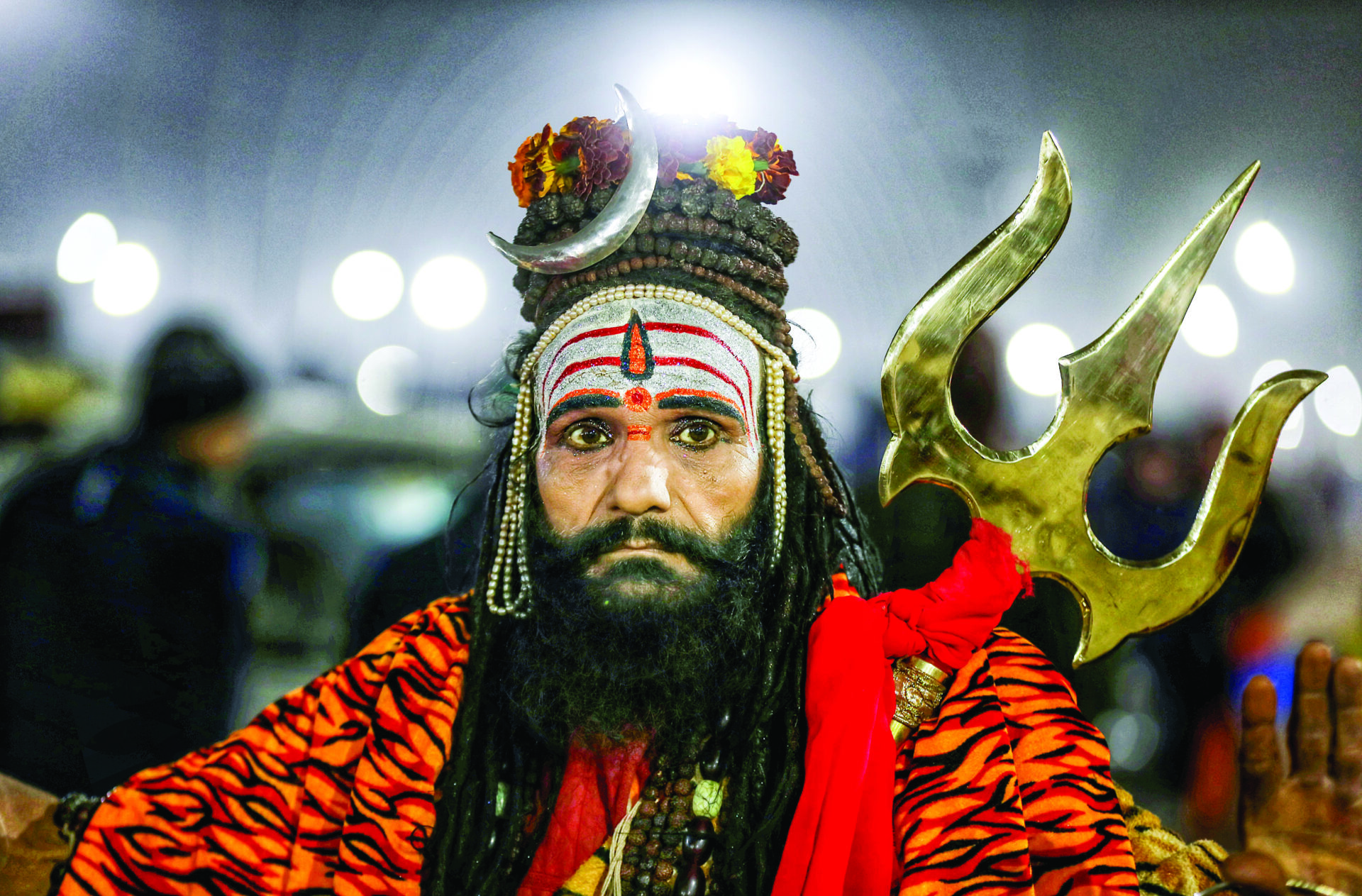 A sadhu holds a trishul at Triveni Sangam during Maha Kumbh 2025, in Prayagraj on 15 January. ANI