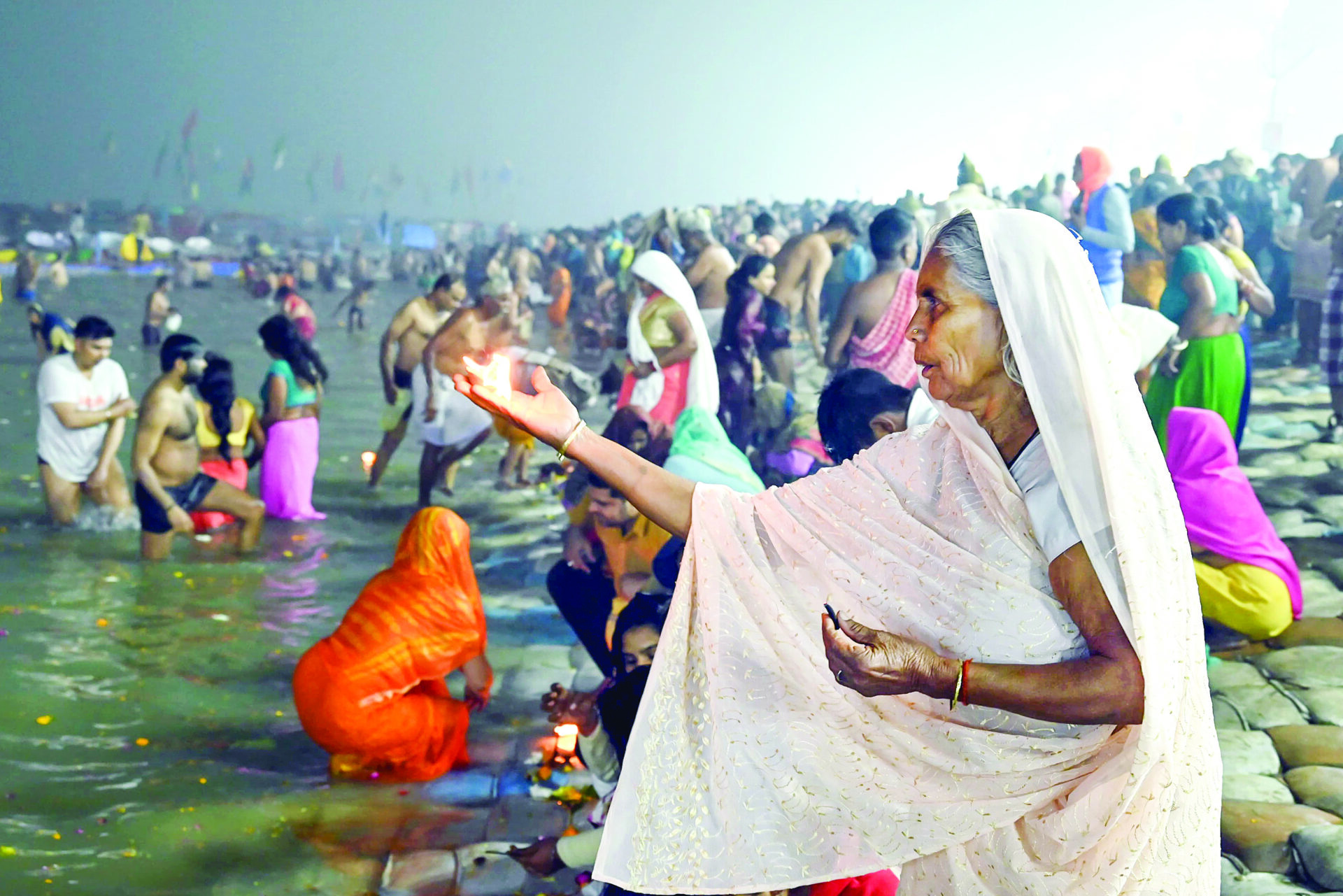 A devotee offers prayers at Triveni Sangam on the occasion of Paush Purnima during Maha Kumbh 2025, in Prayagraj on 13 January. ANI