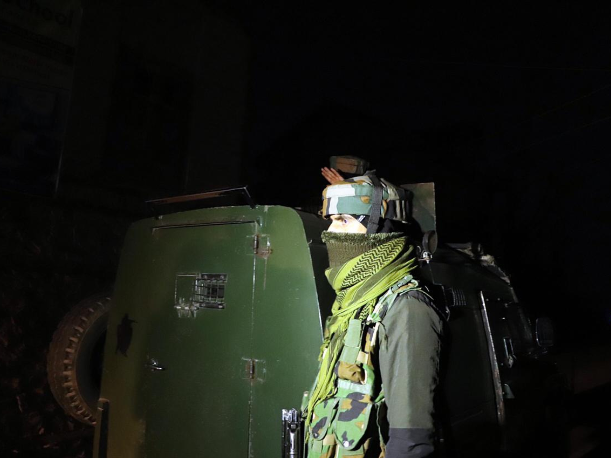 Security personnel take position during an intense gunbattle in Rajouri’s Kandi forests