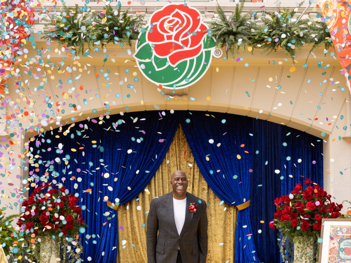 Magic Johnson waves to the crowd as grand marshal - Photo Gallery