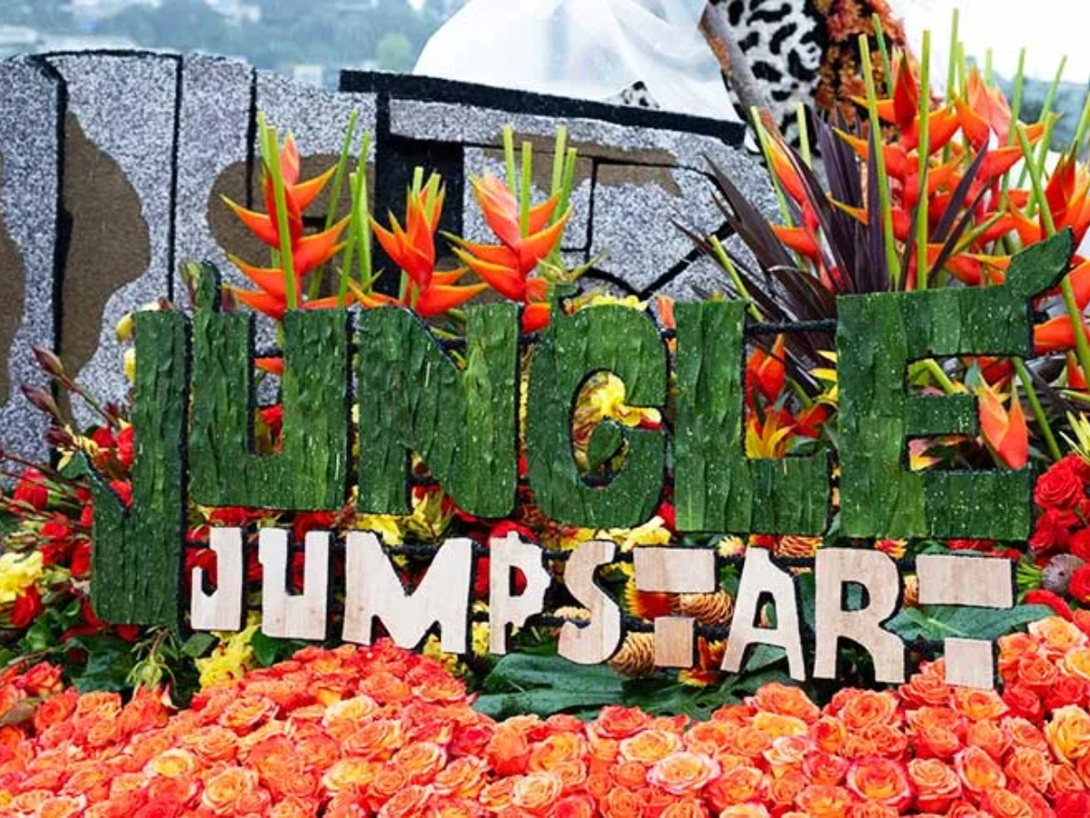 Rainforest animals surround a towering robot on the float. - Photo Gallery