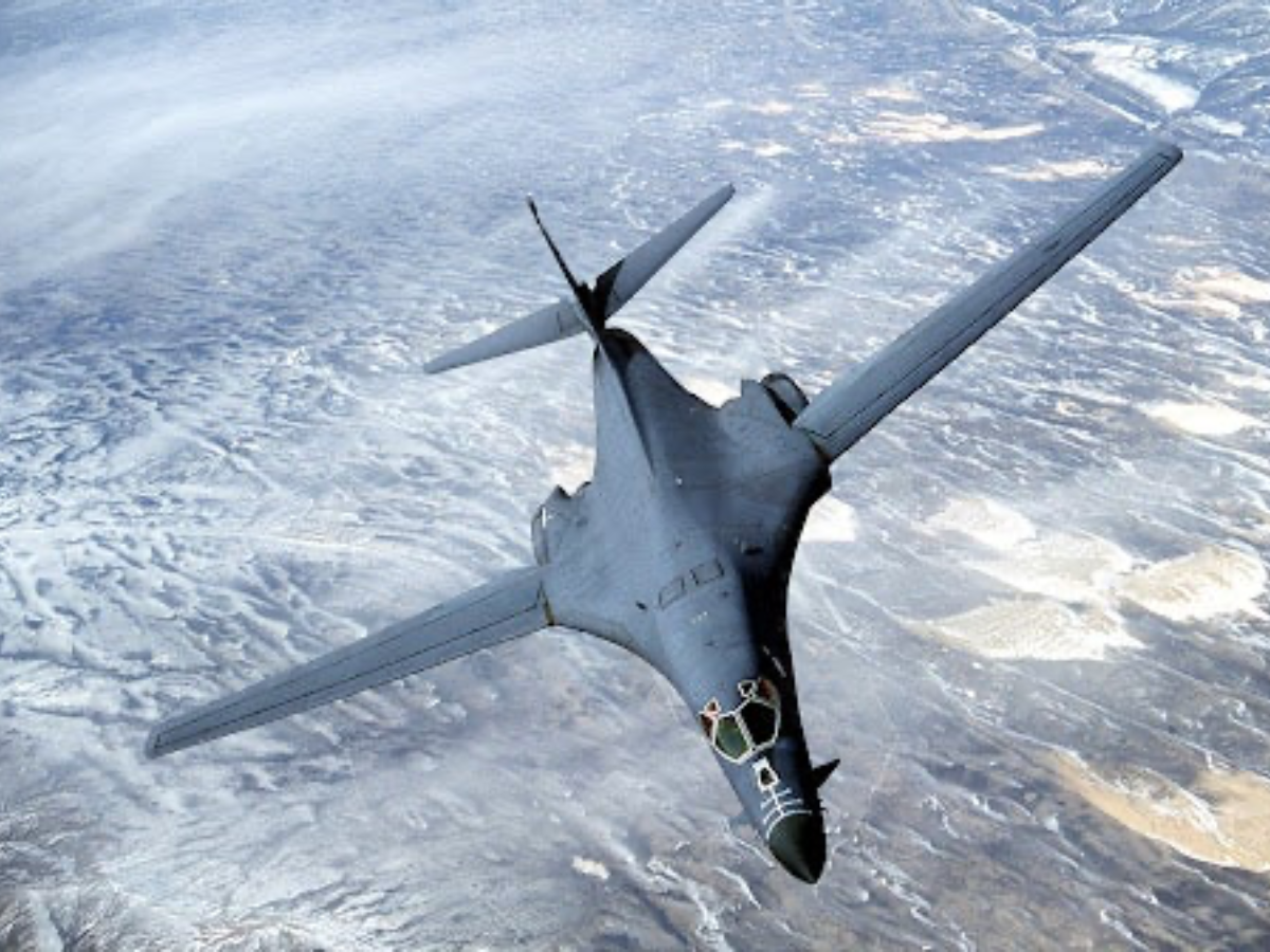 B-1B flying at high altitude with sunrise backdrop. - Photo Gallery