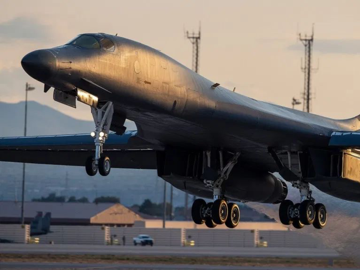 B-1B parked on runway with maintenance crew. - Photo Gallery